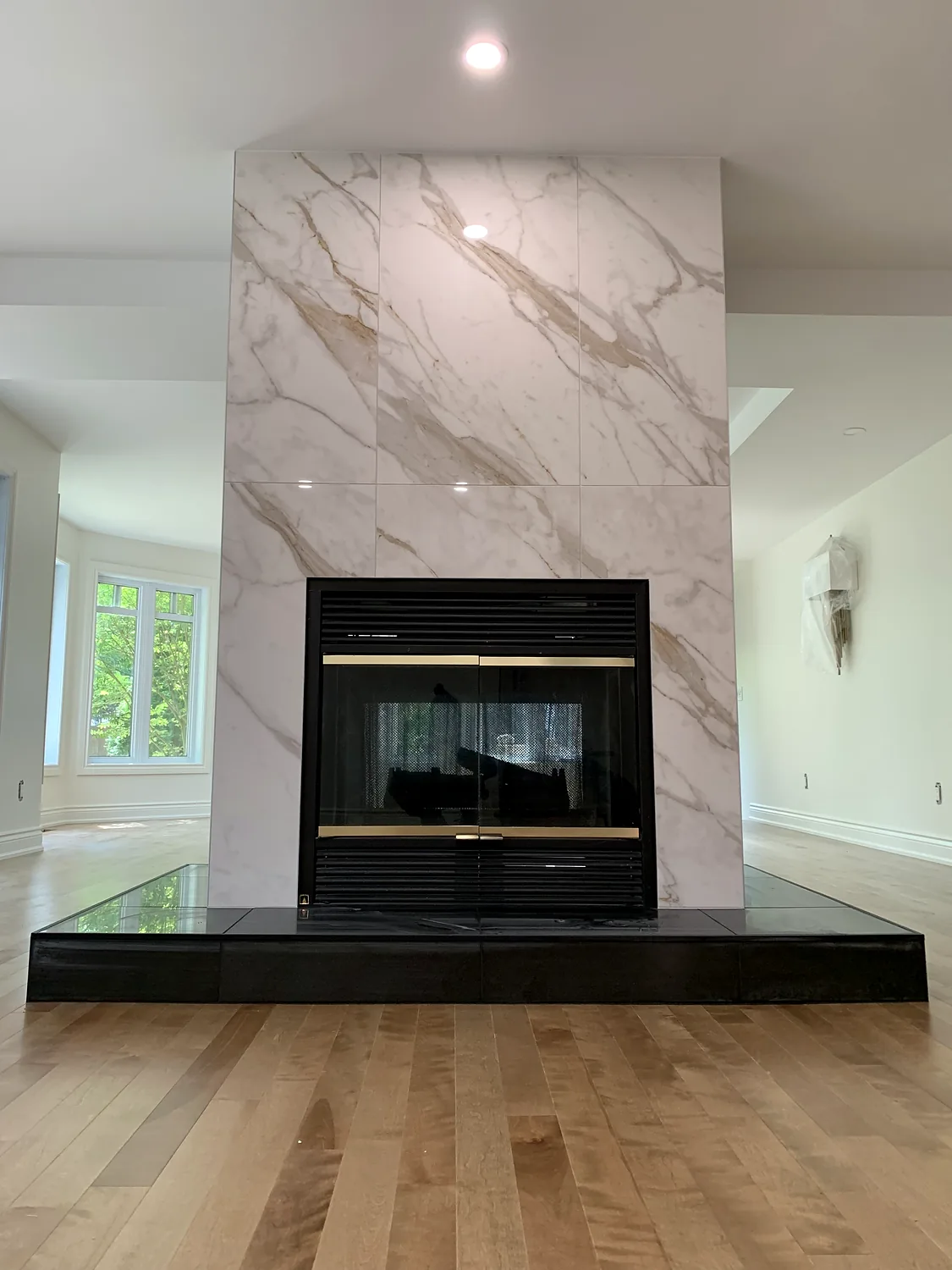 Marble-look surround taken the full height of the wall