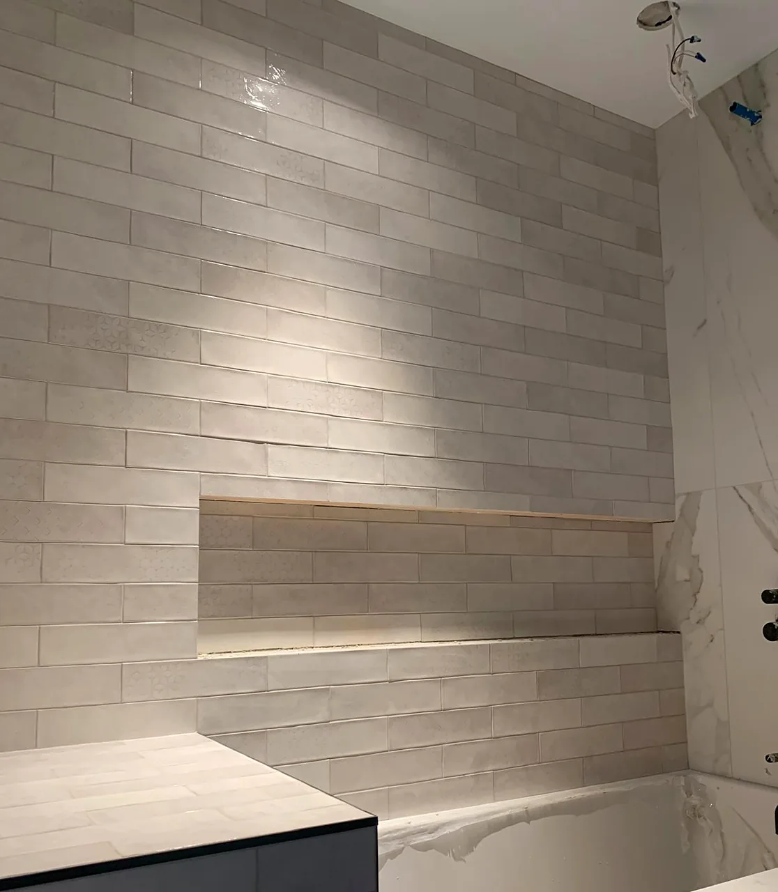 Long niche cut into large-format tile