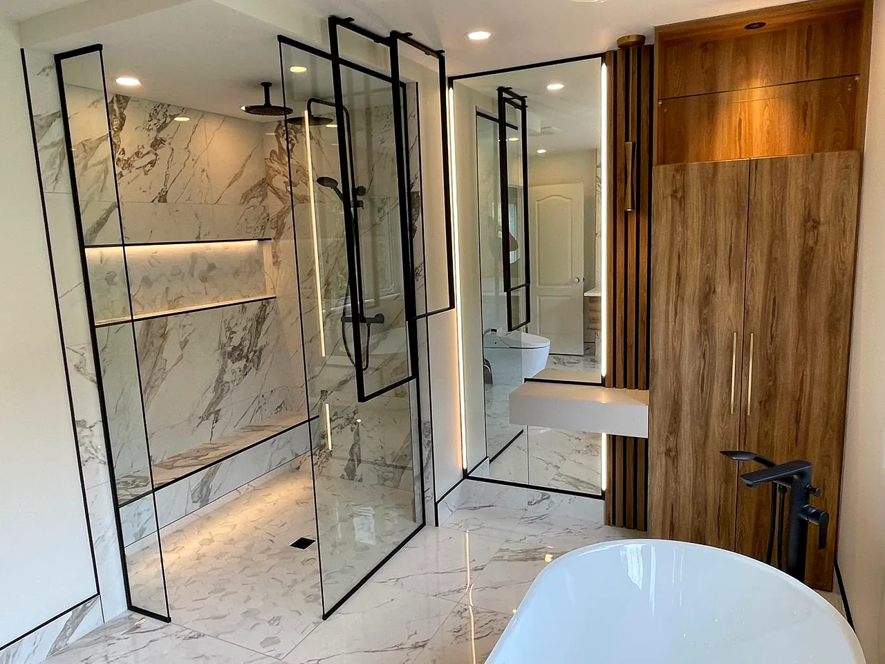Marble-look ensuite, black-framed glass