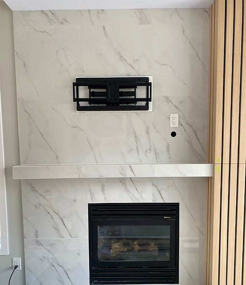 Marble-look mantel, wood slats either side