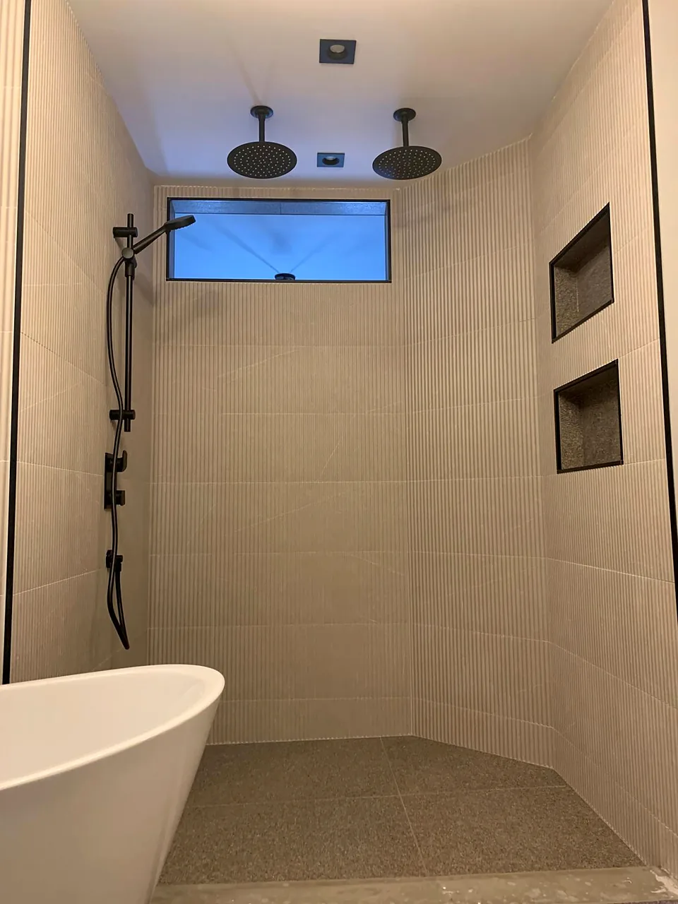 Ribbed tile, curbless shower, freestanding tub