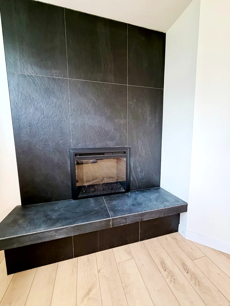 Slate corner surround with a hearth bench
